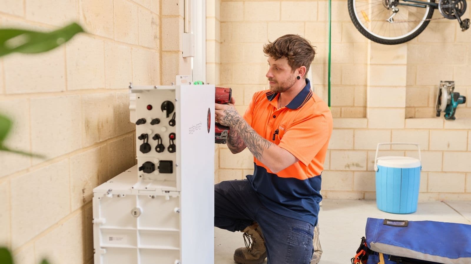 A PSW Energy technician installing a battery system in a Perth garage