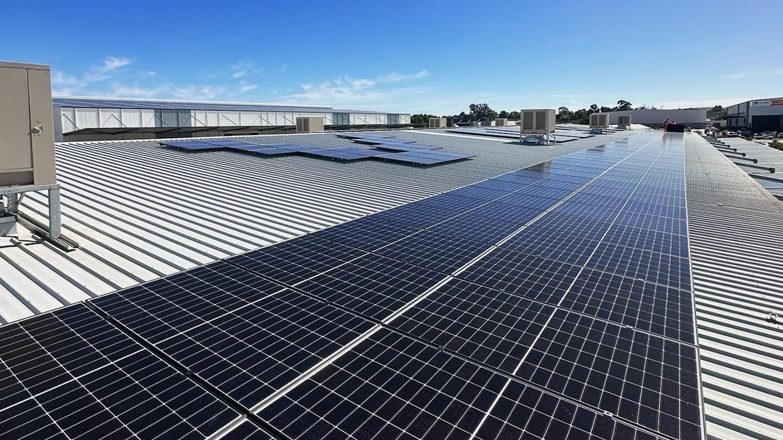A commercial rooftop solar array on an industrial building in Perth