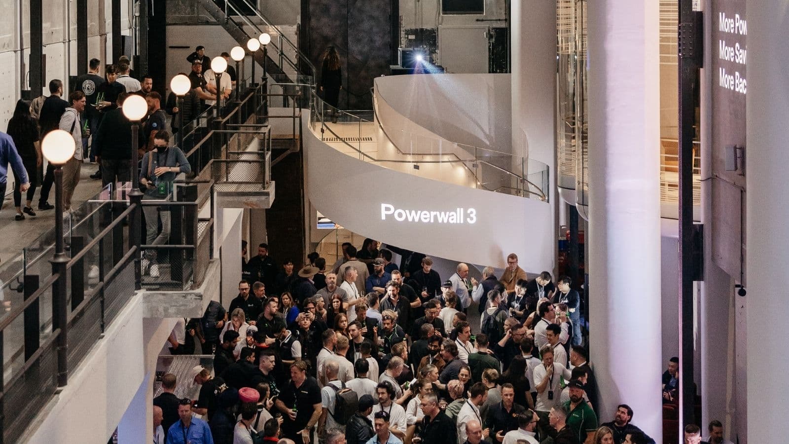 The floor of the Tesla Powerwall 3 Australian product launch in Sydney in August 2024, crowded with attendees beneath Powerwall 3 signage